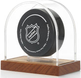 Clear acrylic hockey puck display case with wood base, front view showcasing elegant design.